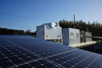 NEC ES storage systems with solar PV panels in foreground. Image: NEC ES.